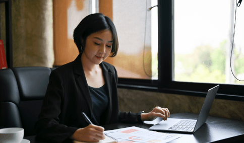 A translator compares a birth certificate and Korean draft for Korean Translation Services in New York City.
