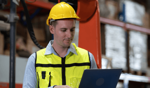 An engineer reviews a CAD manual for Translation Services in Brooklyn, confirming technical terms match the design notes.