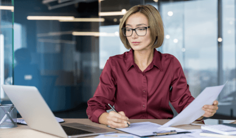 A translator checks ISO formatting on a certified financial translation using Russian Translation Services in New York City.