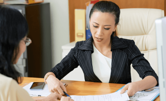 A certified linguist reviews a contract for Korean Translation Services in New York City at a Midtown office desk.