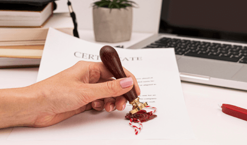 A translator stamps and signs an official document for Korean Translation Services in New York City certification.