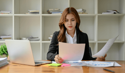 A translator compares balance sheet figures, delivering Spanish Translation Services in New York City for financial reports.