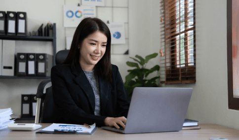 A person checks a word-for-word certified translation on a laptop, using Translation Services in Bushwick at home.