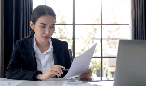 A translator compares Chinese and English balance sheets using Chinese Translation Services in New York City for finance.