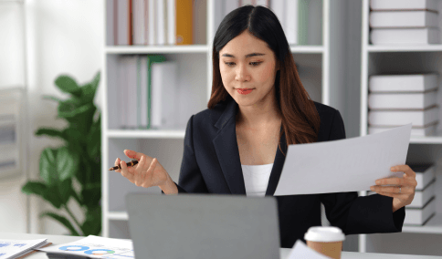 A proofreader marks edits on a bilingual page, demonstrating Translation Services in Harlem built around accuracy checks.