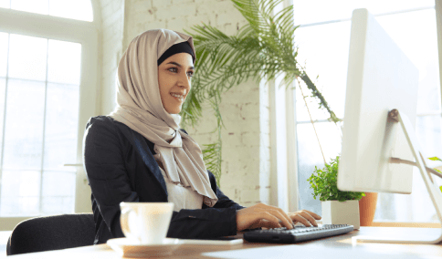 A client downloads a certified legal PDF translation on a laptop, using Arabic Translation Services in New York City.