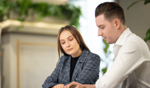 Two managers review a bilingual contract, using Russian Translation Services in New York City for business documents.
