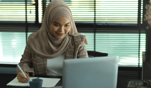 A translator compares Arabic tax forms to an English version, delivering Arabic Translation Services in New York City.