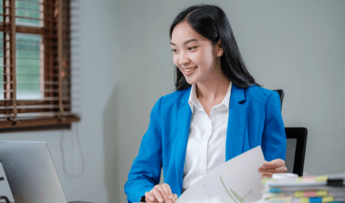 A translator compares a diploma to the translated copy while Translation Services in Washington Heights handle academic.